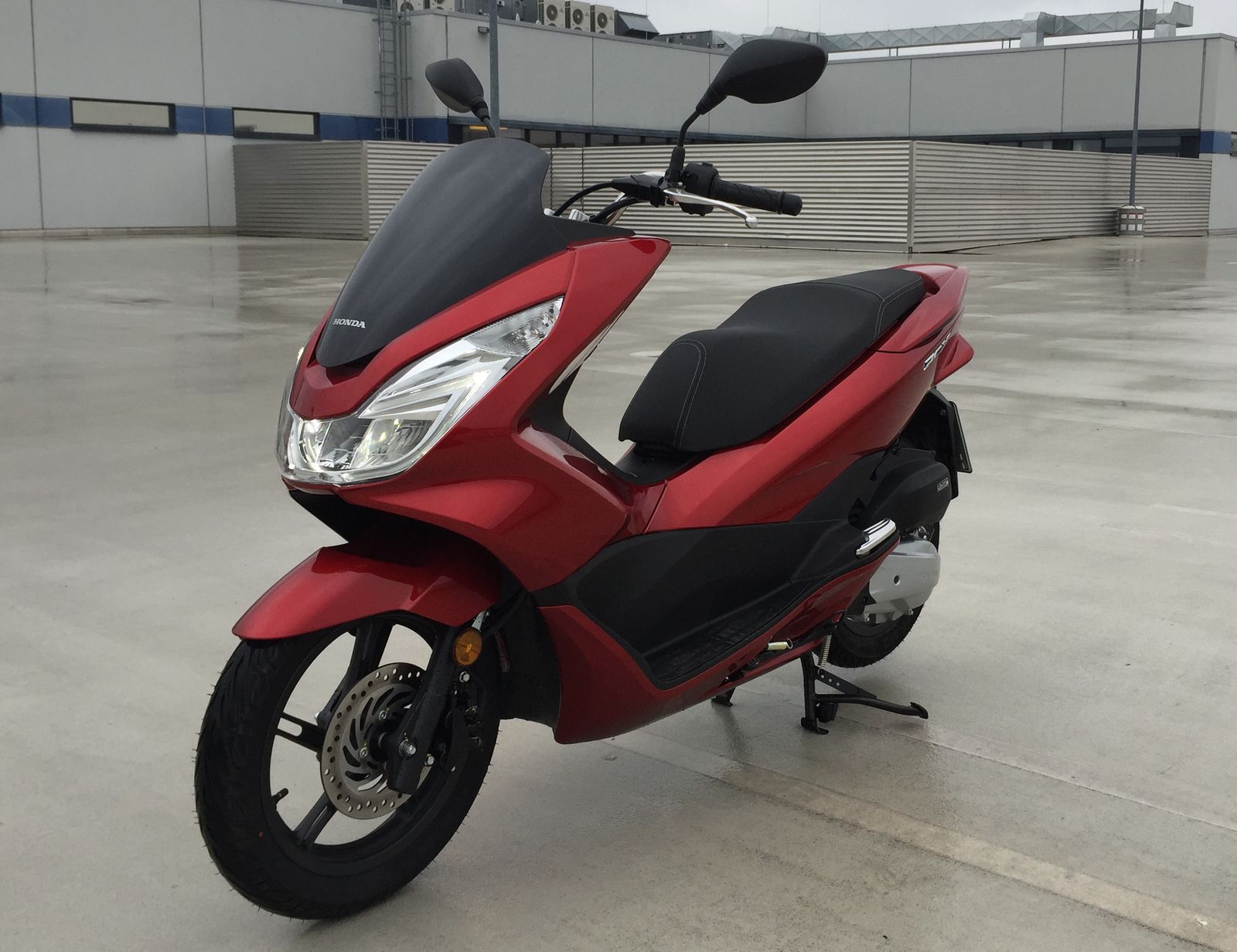 Red Honda PCX scooter, similar to the Honda PCX 150 Gus uses for the DMV skills test